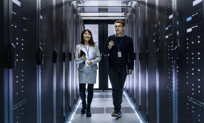 two employees walking in a server room