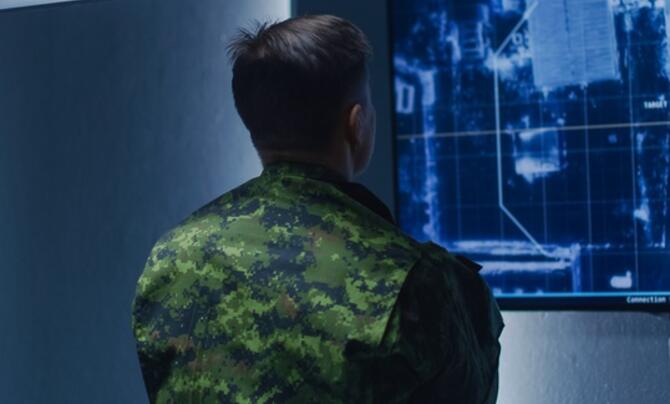 solider looking at surveillance screen
