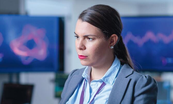 photo of an IT employee working at her desk