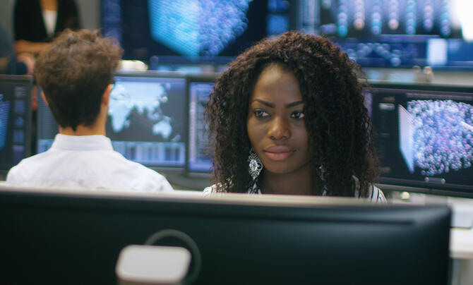 Infrastructure support analyst at work in operations center