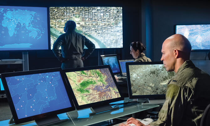 Military personnel viewing a map in a command center