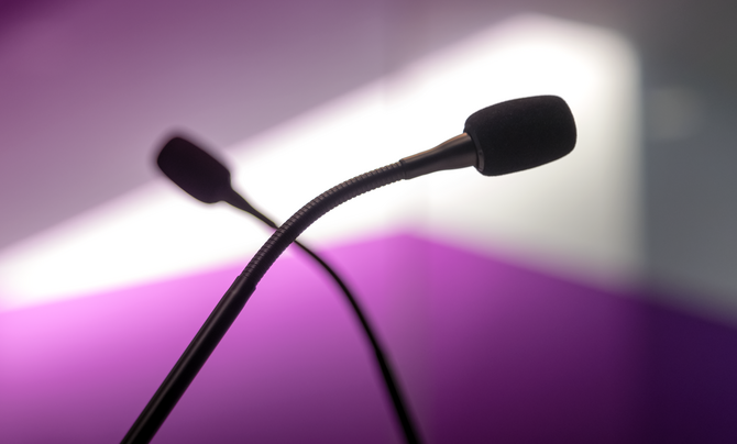 two crossed podcast microphones