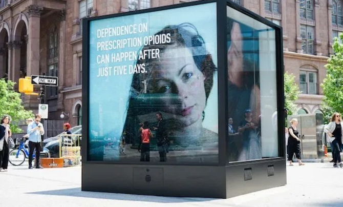 billboard warning about opioid addiction in a city