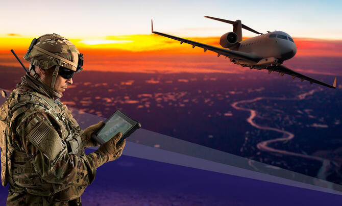 Soldier using tablet to control an airplane