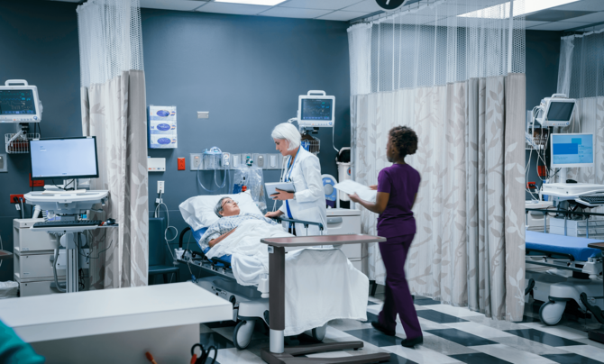 patient in hospital bed with doctor consulting