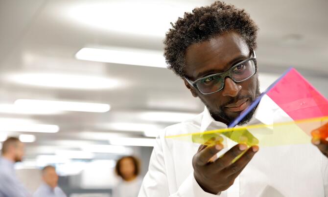 man looking at plastic models