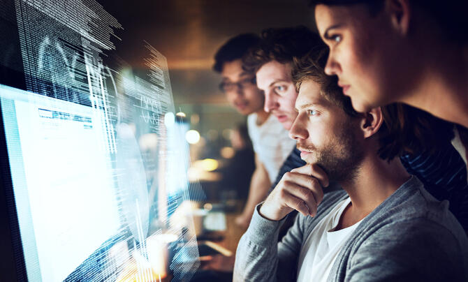 people looking at monitor 