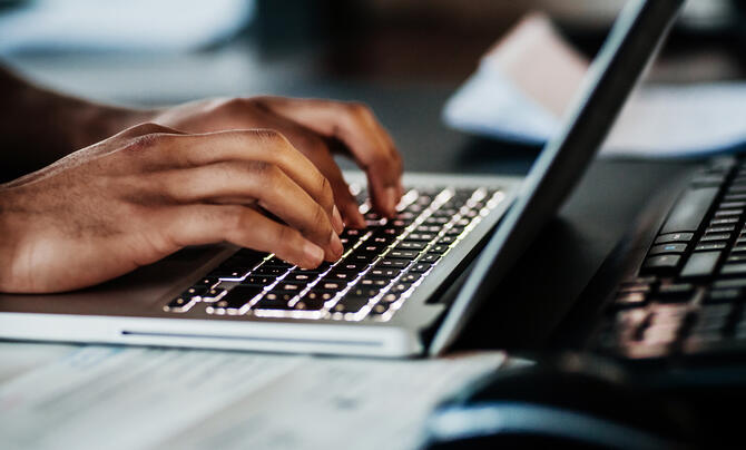 person typing on laptop
