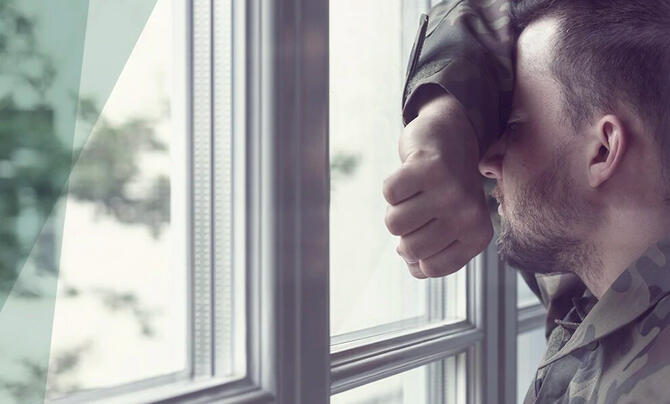 Veteran standing near window