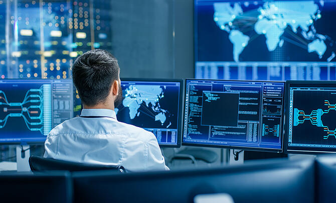 control room with screens and maps