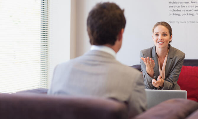 Woman talking to man in interview setting