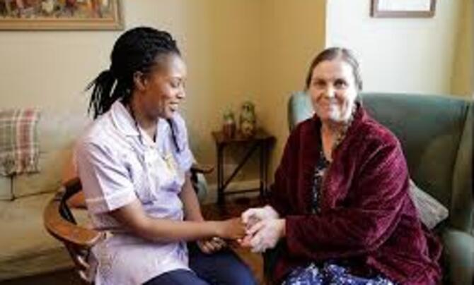 nurse in care home with older woman
