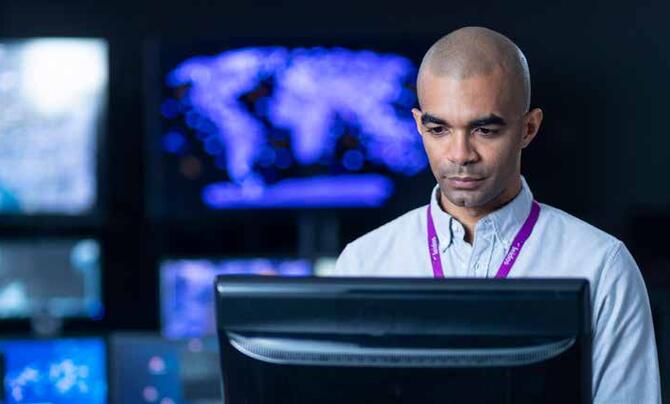 Leidos male employee using computer 