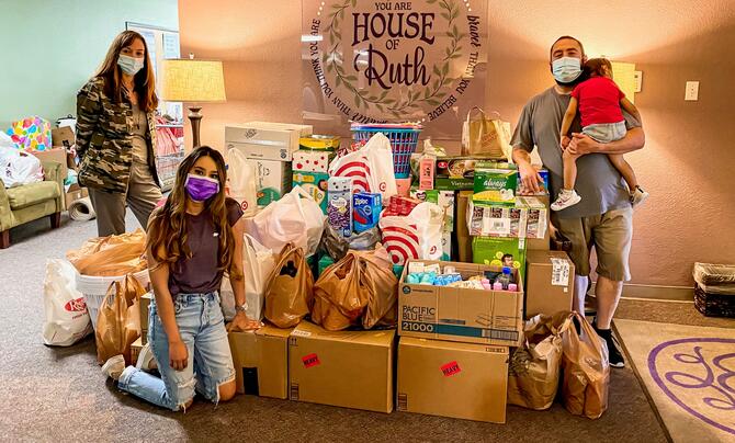 QTC volunteers with donated items at House of Ruth