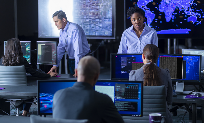 employees working in data center monitor cyber analytics