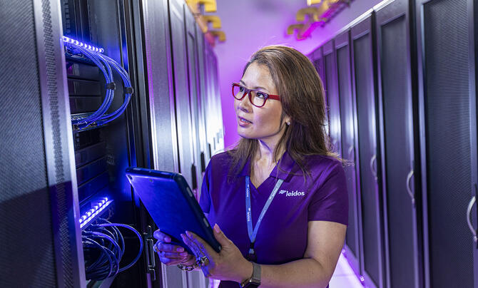 female wearing leidos polo shirt with tablet