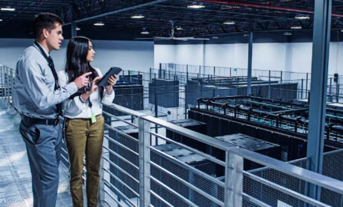 Man and woman overlooking server room