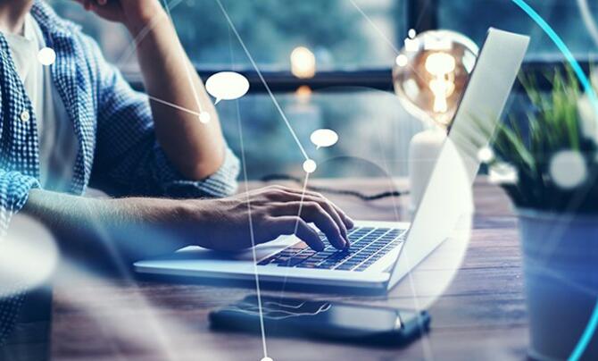 man typing on laptop keyboard