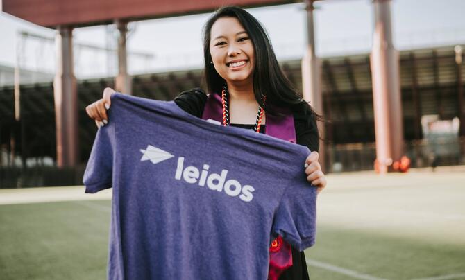 T. Van holding Leidos shirt