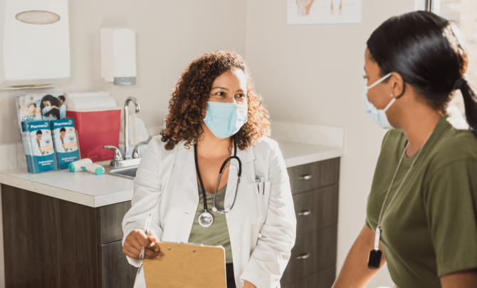 doctor with mask on treating patient