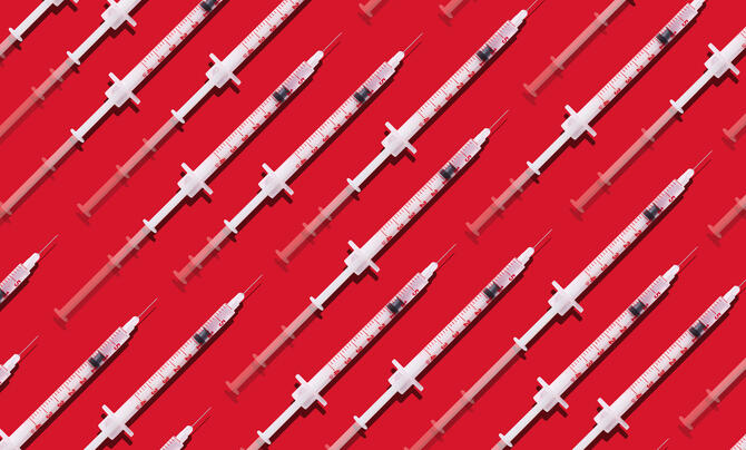 syringes on red backdrop 