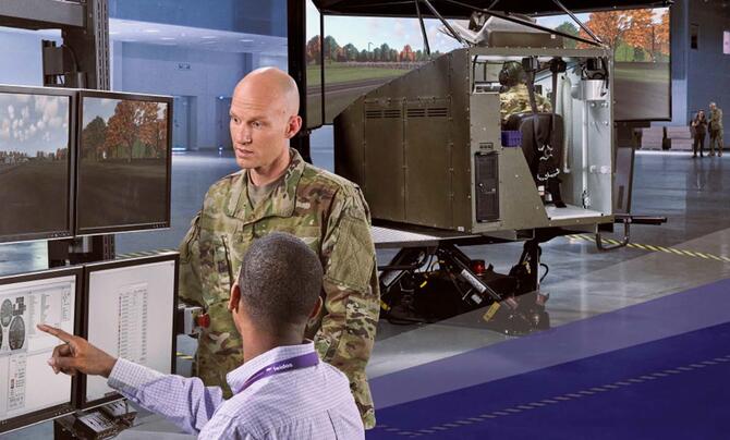 Military officer and Leidos employee looking at dashboards 