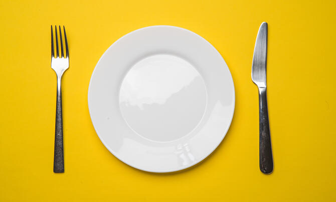 Fork, plate, and knife set with a yellow background