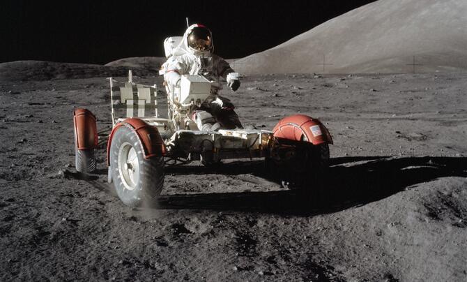 Astronaut driving the Lunar Roving Vehicle on the moon