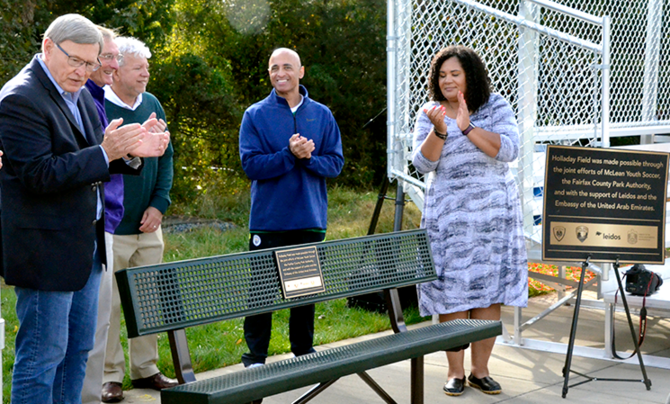 ribbon cutting over dedicated park bench
