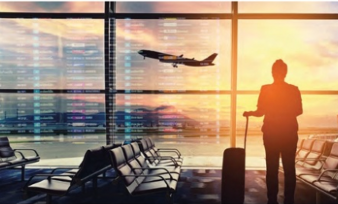 person in airport looking at airplane takeoff
