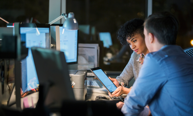 woman and man looking at tablet