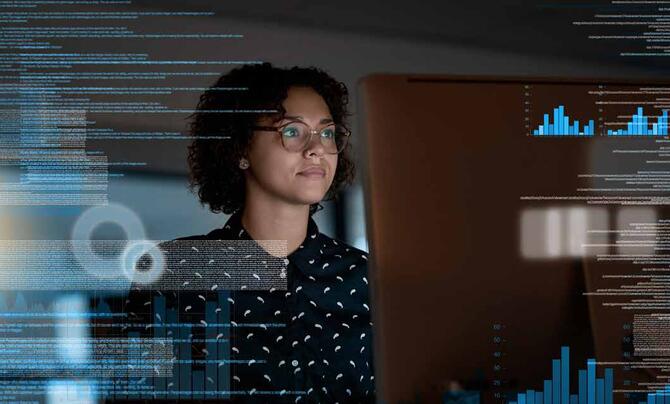 women developer look at screen with dashboard graphic