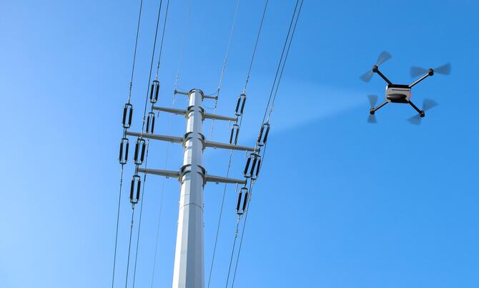 A drone inspecting electricity power lines