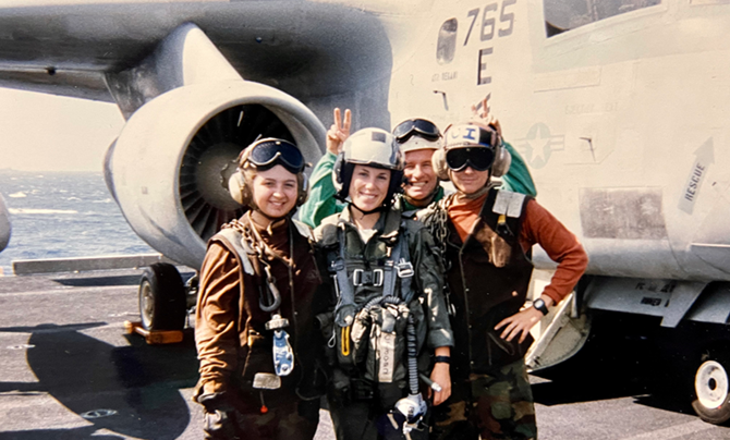 Lisa with colleagues in front of Navy plane