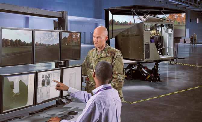 Two men discussing content on a screen