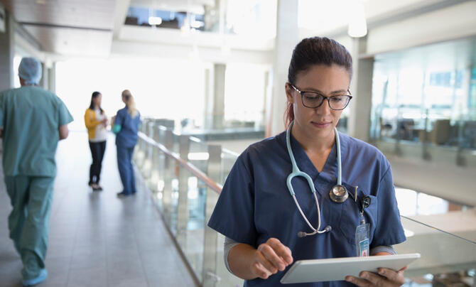 Women with stethoscope walking in hospital