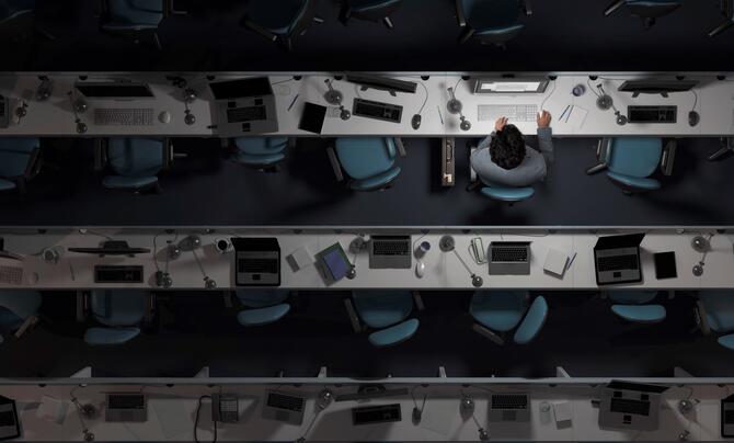 employee working on computer in an otherwise empty office