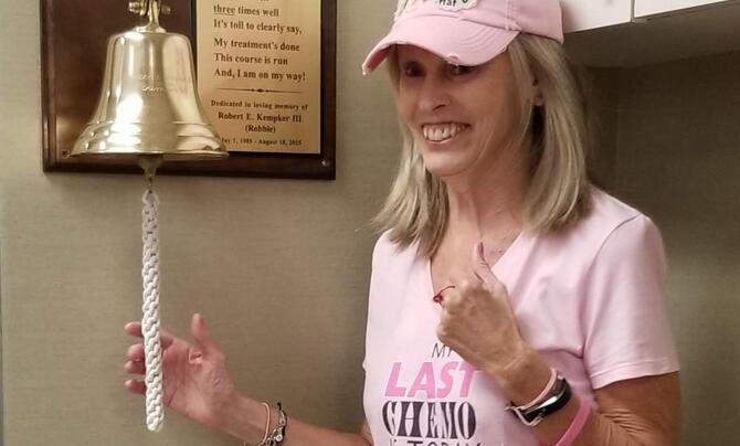 Dinah Ray rings a bell to announce her final chemotherapy treatment