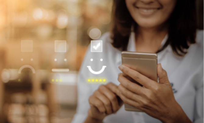 A woman holding a phone with interactive icons being shown