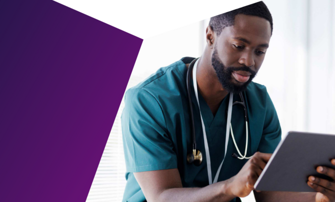 A doctor sitting down with a tablet in hand