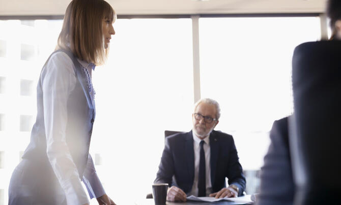 Executives discussing topics in a board room