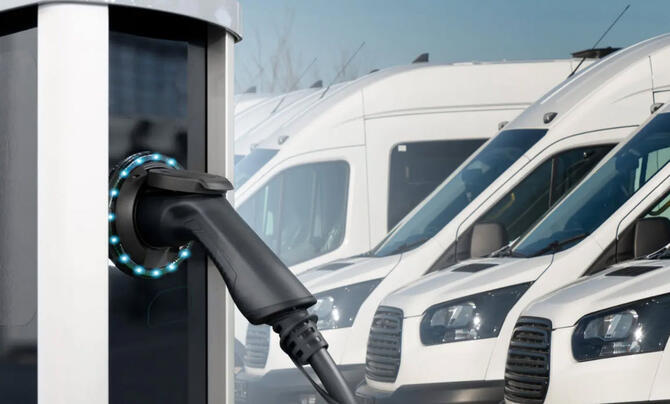 A line of trucks being charged by an electric charger