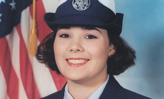 Melissa Tamayo in military uniform in front of the American flag