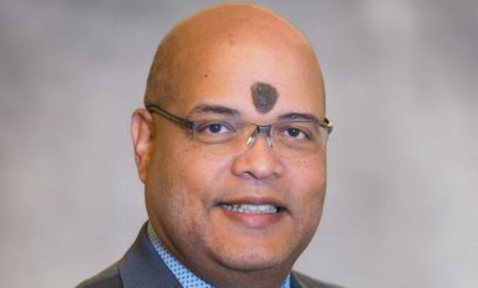 Dr. Braulio Cabral headshot picture on a gray background
