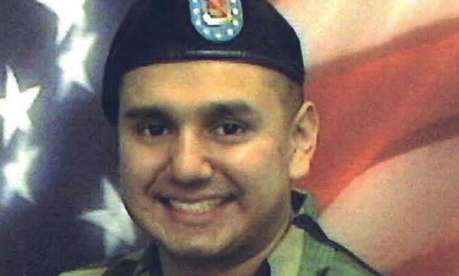 Manuel Pacheco military picture in front of the American flag