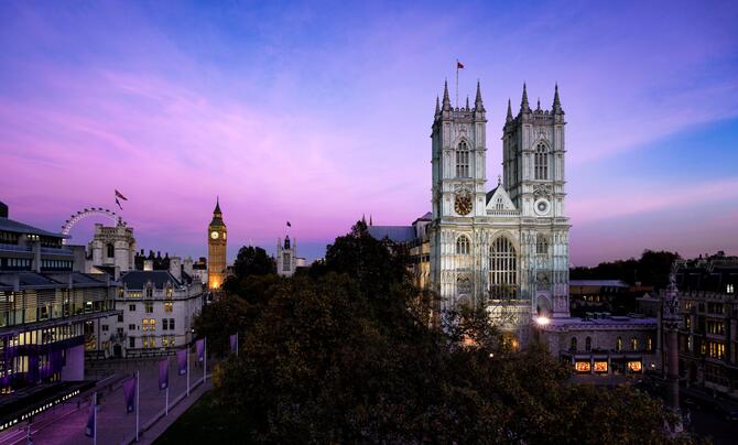 Westminster Abbey in London underneath a blue and purple sky