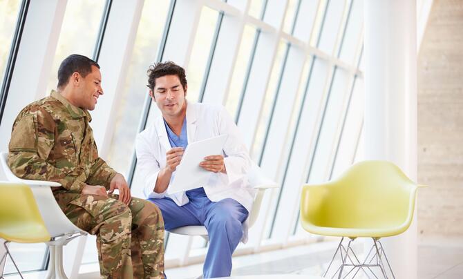 A doctor talking to a military man