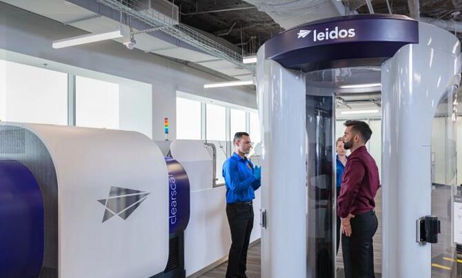 man standing in scanning tube at airport