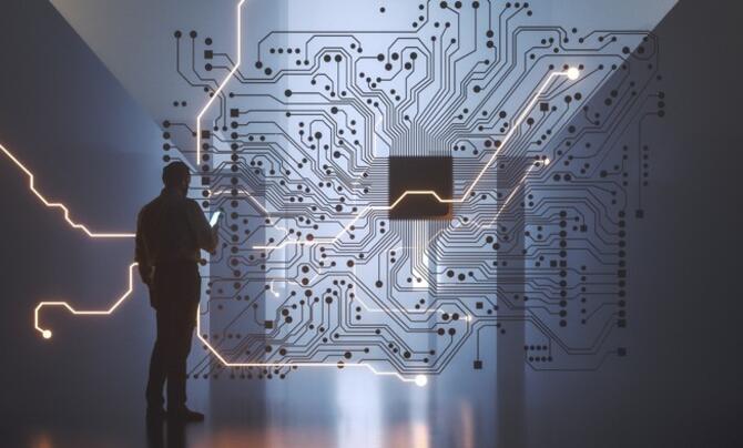 A man standing in front of a board with graphics on it