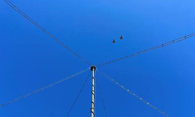 The Marine Expeditionary Long-Range Persistent Surveillance (MELPS) prototype with two fighter jets flying overhead 